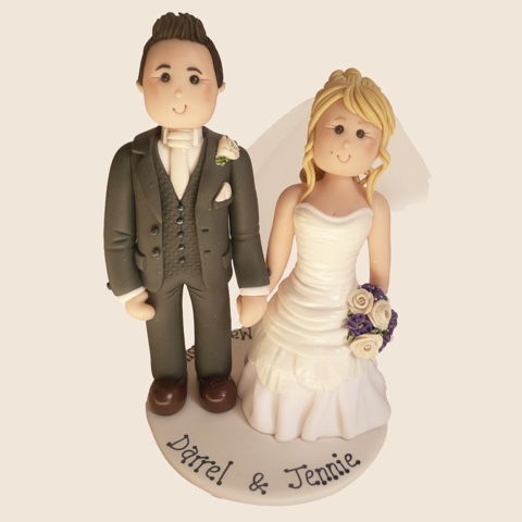 Hand-made wedding cake topper of bride and groom